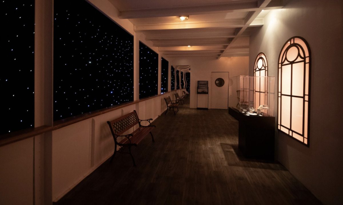 The promenade deck against a cozy nighttime sky. 