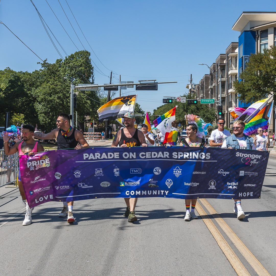 Folks marching carrying pride signage