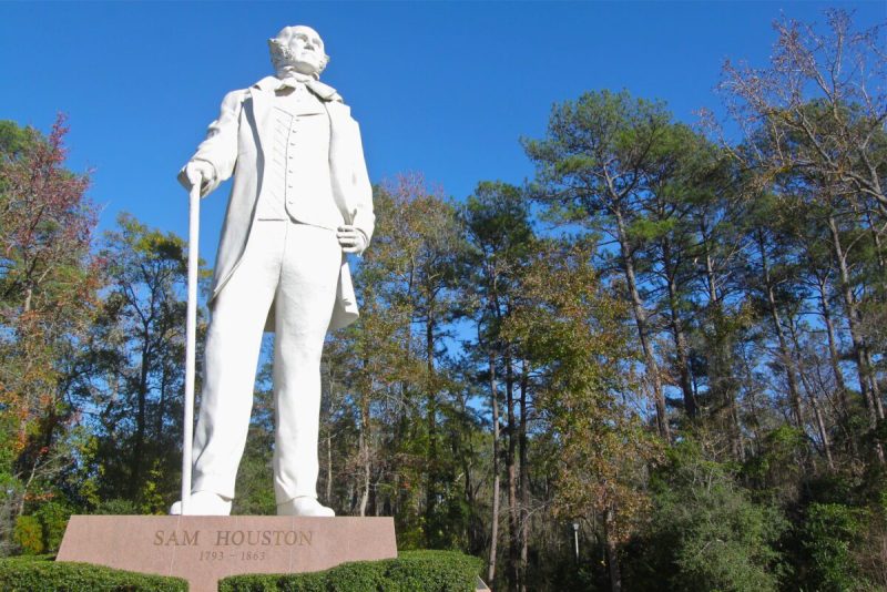 a white statue of houston namesake sam houston against the blue sky
