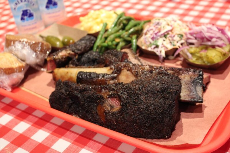 a plate of texas bbq with green beans, slaw, and more.